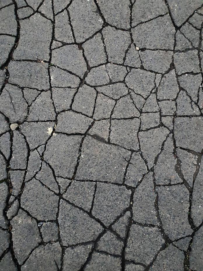 Asphalt surface broken into small interconnected blocks