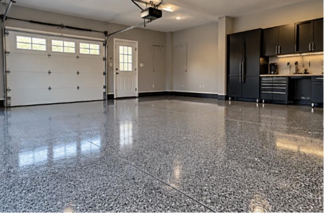 Two-car garage with a glossy gray flake epoxy floor and black cabinets