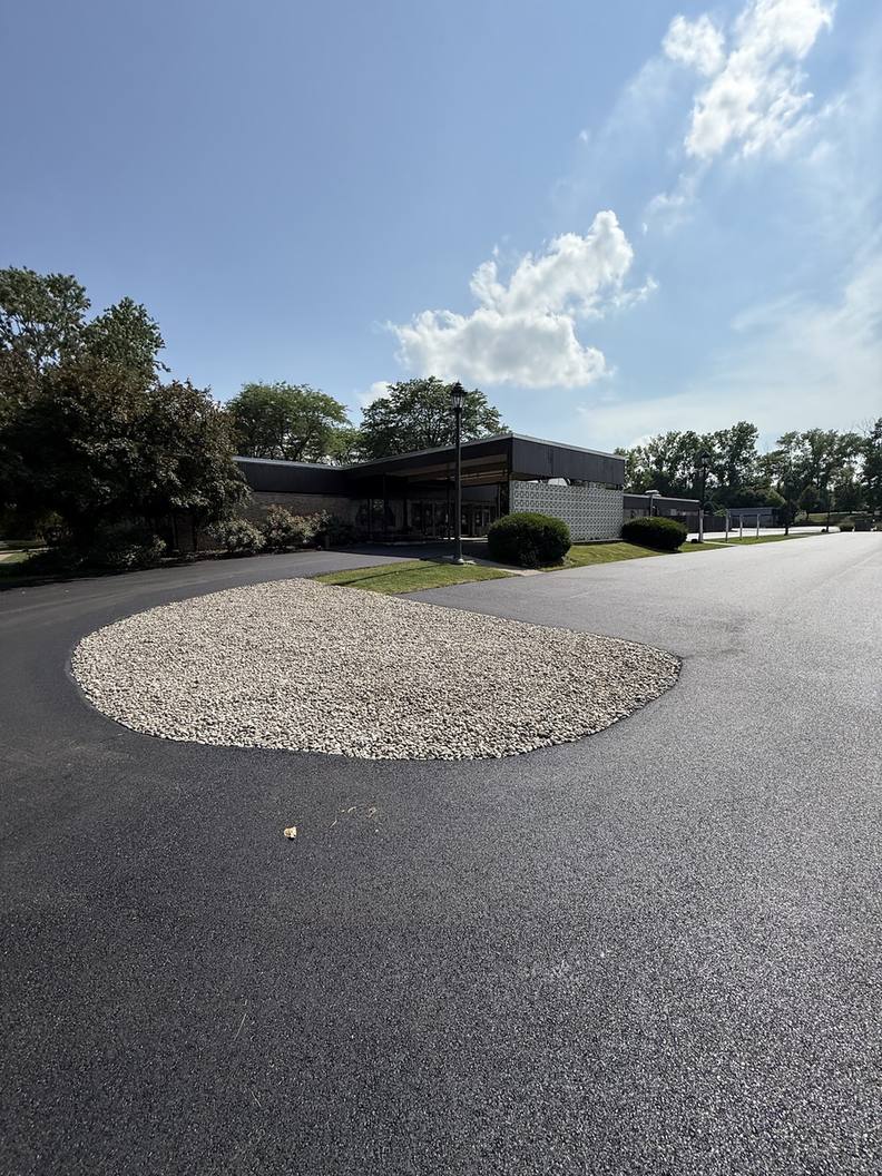 Newly paved parking lot with a landscaped center island